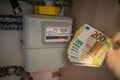 next to a gas meter is held a lot of two hundred euro banknotes Royalty Free Stock Photo