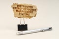 Next to the handle is an office clip with a sign. On the plate is the inscription - DERMS