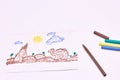 Next to the markers is a primitive children`s drawing with a felt-tip pen on a white background. child development Royalty Free Stock Photo