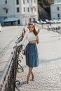 Fashion lifestyle portrait of young happy pretty woman laughing and having fun on the street at nice sunny summer day Royalty Free Stock Photo