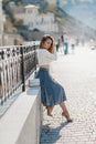 Fashion lifestyle portrait of young happy pretty woman laughing and having fun on the street at nice sunny summer day Royalty Free Stock Photo