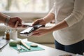 NFC technology. Customer is paying. Close up of guest using smart phone while making contactless payment in a pub. Royalty Free Stock Photo