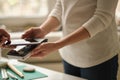 NFC technology. Customer is paying. Close up of guest using smart phone while making contactless payment in a pub. Royalty Free Stock Photo