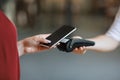 NFC Technology. Unrecognizable woman maiking contactless payment with smartphone to terminal