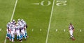 NFL - the huddle and the ref Royalty Free Stock Photo