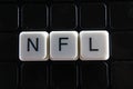 NFL title text word crossword. Alphabet letter blocks game texture background. White alphabetical letters on black