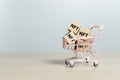 NFT non-fungible concept. Wooden cube blocks with alphabet NFT on shopping trolley. Non Fungible Token online electronic currency