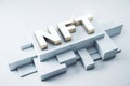 NFT nonfungible tokens concept - NFT word in white frame on abstract technology background.