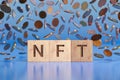 NFT Word in Front of Falling Coins Background