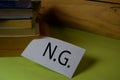 NG write on a sticky note isolated on Office Desk. Business Document concept Royalty Free Stock Photo