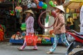 Women walking through a Mekong Delta street market in Nga Bay, V