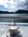 A cup of chocolate with beautiful lake view