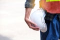 Ngineer worker standing in the construction container shipping yard holding safety helmet Royalty Free Stock Photo