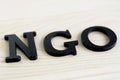 NGO letters on wood background