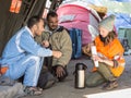 NGO Volunteers providing assistance to two refugee men waiting to cross the Serbia Croatia border