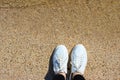 Quiet surf, yellow sand and white sneakers