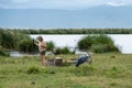 A woman takes a selfie with a Marabou Stork bird (defocused), getting too close to