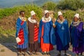 Massai woman stay together at sunset in Tanzania, Africa in traditional colorful Dress and African Jewelry