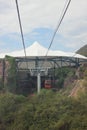 Nha Trang, Viet Nam - 13 July,2015: Red cable cars are moving with green mountain and blue sky Royalty Free Stock Photo