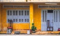 Nha Trang, Vietnam - January 4, 2019: The facade of the house is yellow with closed wooden shutters on the windows