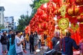 Vietnamese people posing for photos against many decorations in the market for Tet Lunar New Year