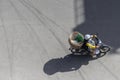 Nha Trang, Vietnam - January 7, 2019: A woman rides a motorbike with empty baskets on the asphalt Royalty Free Stock Photo