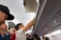 Nha Trang, Vietnam - July 31, 2016: Aircraft passengers taking baggage from cabin after the airplane landed at Noi Bai airport.