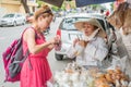 Nha Trang, Vietnam: A solo woman traveler buys sweets from a Vietnamese lady