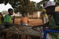 Group of children playing a game of checkers under a tree in the town of Nhacra in Guinea Bissau Royalty Free Stock Photo