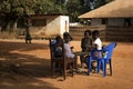 Group of children playing a game of checkers under a tree in the town of Nhacra in Guinea Bissau