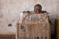 Portrait of a young boy playing in a card box in the town of Nhacra in Guinea Bissau