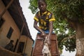 Young African boy washing his clothes in a washing board in the town of Nhacra in Guinea Bissau