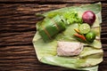 Nham sour pork in banana leaves thai food Royalty Free Stock Photo