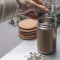 Metal thermos mug brewing herbal tea.