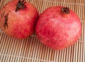 Two ripe pomegranates on a texture background