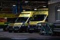 NHS Ambulance station with fleet of clean ambulances parked waiting for emergency incident response to accident and emergency Royalty Free Stock Photo