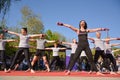 Dynamic Piloxing Training: Energetic Group with Instructor in Black T-Shirt and Microphone Royalty Free Stock Photo