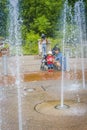 Water fountains in activity as mother and child watch