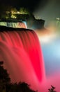 Niagara Falls lit at night show by colorful lights. USA Royalty Free Stock Photo