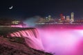 Niagara Falls lit up at night under the moon Royalty Free Stock Photo