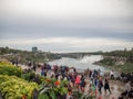 Niagara Falls, New York and Canada [ edge of Niagara falls, town from American and Canadian city side, falling water and mist ] Royalty Free Stock Photo