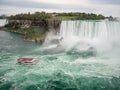 Niagara Falls, New York and Canada [ edge of Niagara falls, town from American and Canadian city side, falling water and mist ] Royalty Free Stock Photo