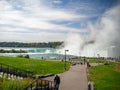 Niagara Falls, New York and Canada [ edge of Niagara falls, town from American and Canadian city side, falling water and mist ] Royalty Free Stock Photo