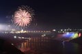 Niagara falls at night illuminated with different colors and fireworks. Royalty Free Stock Photo