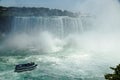 Niagara Horseshoe Falls with a touristic vessel Maid of the Mist approaching. The falls height is 57 m and they throw Royalty Free Stock Photo