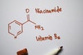 Niaoinamide Vitamin B3 molecule written on the white board. Structural chemical formula. Education concept