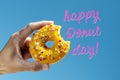 Nibbled donut and text happy donut day