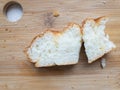 Nibbled slice of bun lying on a cut bamboo board Royalty Free Stock Photo