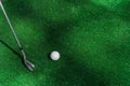 Niblick and white ball for golf on the green grass. Empty right side for text of advert for golf clubs Royalty Free Stock Photo