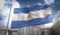 Nicaragua Flag 3D Rendering on Blue Sky Building Background